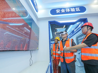 Workers are simulating a production safety accident at a VR safety experience hall in Huzhou, Zhejiang province, China, on June 11, 2024. (