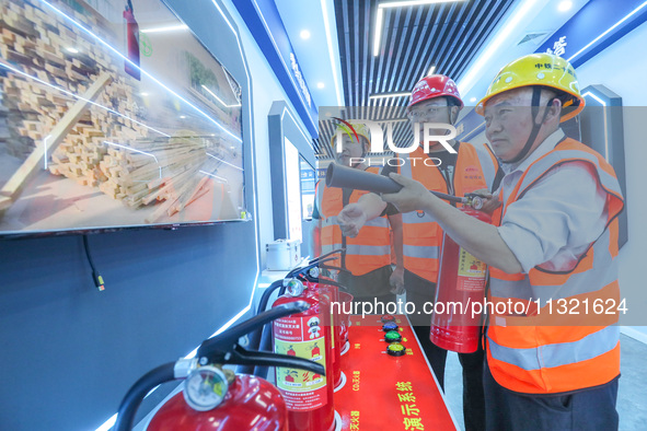 Workers are performing a firefighting experience in Huzhou, Zhejiang province, China, on June 11, 2024. 