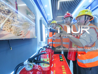 Workers are performing a firefighting experience in Huzhou, Zhejiang province, China, on June 11, 2024. (