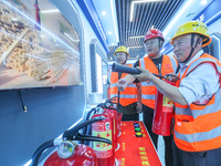 Workers are performing a firefighting experience in Huzhou, Zhejiang province, China, on June 11, 2024. (