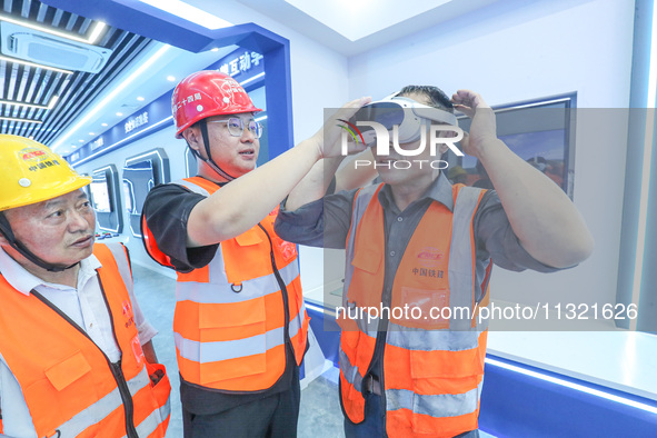 Workers are simulating a production safety accident at a VR safety experience hall in Huzhou, Zhejiang province, China, on June 11, 2024. 