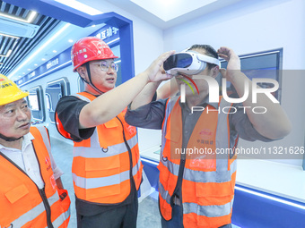 Workers are simulating a production safety accident at a VR safety experience hall in Huzhou, Zhejiang province, China, on June 11, 2024. (