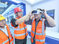 Workers are simulating a production safety accident at a VR safety experience hall in Huzhou, Zhejiang province, China, on June 11, 2024. (