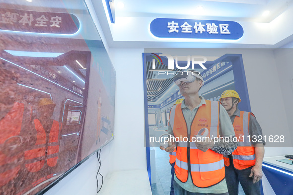 Workers are simulating a production safety accident at a VR safety experience hall in Huzhou, Zhejiang province, China, on June 11, 2024. 