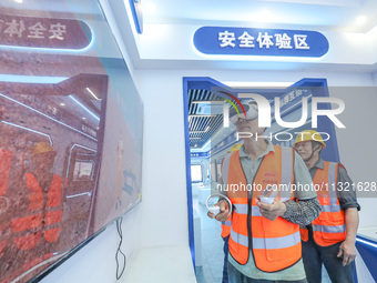 Workers are simulating a production safety accident at a VR safety experience hall in Huzhou, Zhejiang province, China, on June 11, 2024. (