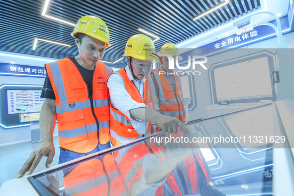 Workers are conducting safety inspections at a VR safety experience hall in Huzhou, China, on June 11, 2024. 