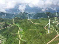 Wind turbines are being seen on a mountain in Qishe township in Xingyi city, Guizhou province, China, on June 11, 2024. (