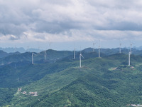 Wind turbines are being seen on a mountain in Qishe township in Xingyi city, Guizhou province, China, on June 11, 2024. (