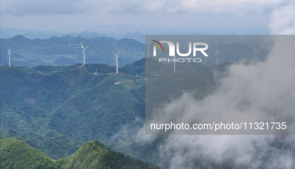 Wind turbines are being seen on a mountain in Qishe township in Xingyi city, Guizhou province, China, on June 11, 2024. 