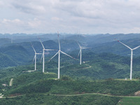 Wind turbines are being seen on a mountain in Qishe township in Xingyi city, Guizhou province, China, on June 11, 2024. (