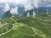 Wind turbines are being seen on a mountain in Qishe township in Xingyi city, Guizhou province, China, on June 11, 2024. (