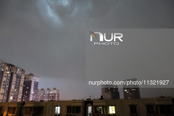 Strong winds, torrential rain, thunder, and lightning are occurring at dusk in Beijing, China, on June 11, 2024. 