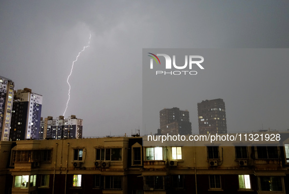 Strong winds, torrential rain, thunder, and lightning are occurring at dusk in Beijing, China, on June 11, 2024. 