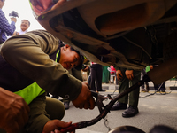 Members of the Lalitpur Metropolitan City Police are inspecting the pollution level of a vehicle by stopping it on the side of a road as a m...