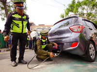 Members of the Lalitpur Metropolitan City Police are inspecting the pollution level of a vehicle by stopping it on the side of a road as a m...