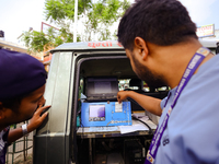 Officials from the Transport Management Office are printing details of a vehicle that is undergoing a pollution level check as the Lalitpur...