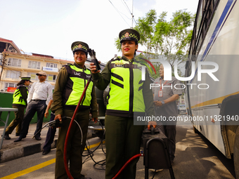 Members of the Lalitpur Metropolitan City Police are inspecting the pollution level of a vehicle by stopping it on the side of a road as a m...