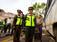 Members of the Lalitpur Metropolitan City Police are inspecting the pollution level of a vehicle by stopping it on the side of a road as a m...