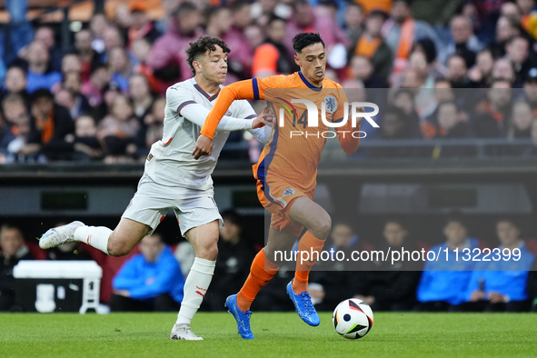 Mikael Anderson Left Winger of Iceland and Aarhus GF and Tijjani Reijnders Central Midfield of Netherland and AC Milan compete for the ball...