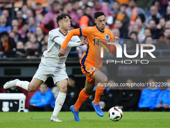 Mikael Anderson Left Winger of Iceland and Aarhus GF and Tijjani Reijnders Central Midfield of Netherland and AC Milan compete for the ball...