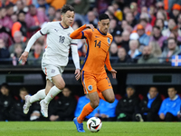 Mikael Anderson Left Winger of Iceland and Aarhus GF and Tijjani Reijnders Central Midfield of Netherland and AC Milan compete for the ball...