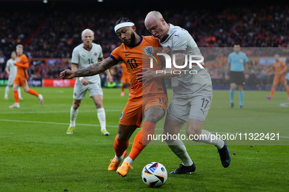 Memphis Depay Centre-Forward of Netherland and Atletico de Madrid and Valgeir Lunddal Fridriksson Right-Back of Iceland and BK Hacken during...