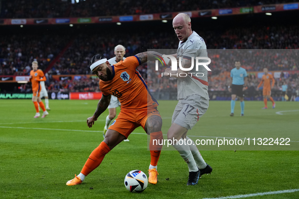 Memphis Depay Centre-Forward of Netherland and Atletico de Madrid and Valgeir Lunddal Fridriksson Right-Back of Iceland and BK Hacken during...