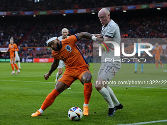 Memphis Depay Centre-Forward of Netherland and Atletico de Madrid and Valgeir Lunddal Fridriksson Right-Back of Iceland and BK Hacken during...