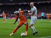 Memphis Depay Centre-Forward of Netherland and Atletico de Madrid and Valgeir Lunddal Fridriksson Right-Back of Iceland and BK Hacken during...