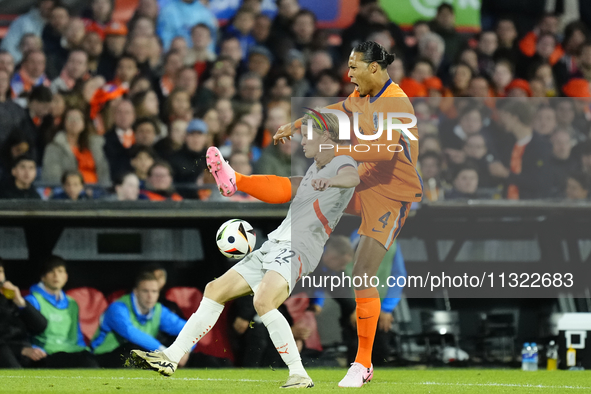 Andri Gudjohnsen Centre-Forward of Iceland and Lyngby BK and Virgil van Dijk Centre-Back of Netherland and Liverpool FC compete for the ball...