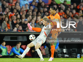 Andri Gudjohnsen Centre-Forward of Iceland and Lyngby BK and Virgil van Dijk Centre-Back of Netherland and Liverpool FC compete for the ball...