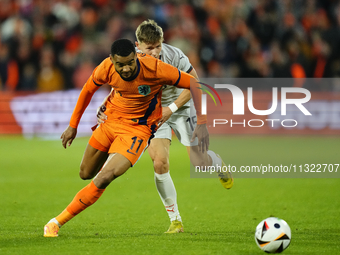 Cody Gakpo Left Winger of Netherland and Liverpool FC and Bjarki Bjarkason Left Winger of Iceland and Venezia FC compete for the ball during...