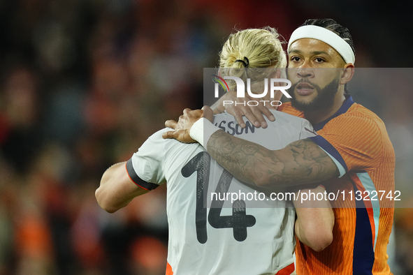 Memphis Depay Centre-Forward of Netherland and Atletico de Madrid and Kolbeinn Finnsson Left-Back Lyngby BK talks during the international f...