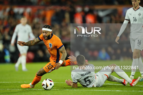 Memphis Depay Centre-Forward of Netherland and Atletico de Madrid and Bjarki Bjarkason Left Winger of Iceland and Venezia FC compete for the...