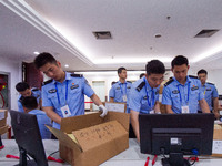 Staff members are performing an orderly scan at a scanning point for the Jiangsu Provincial College Entrance Examination answer sheet in Nan...