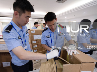 Staff members are performing an orderly scan at a scanning point for the Jiangsu Provincial College Entrance Examination answer sheet in Nan...