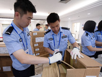 Staff members are performing an orderly scan at a scanning point for the Jiangsu Provincial College Entrance Examination answer sheet in Nan...