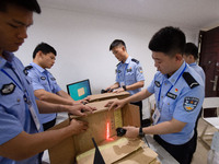 Staff members are performing an orderly scan at a scanning point for the Jiangsu Provincial College Entrance Examination answer sheet in Nan...