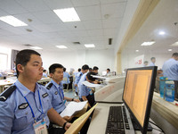 Staff members are performing an orderly scan at a scanning point for the Jiangsu Provincial College Entrance Examination answer sheet in Nan...