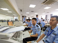 Staff members are performing an orderly scan at a scanning point for the Jiangsu Provincial College Entrance Examination answer sheet in Nan...