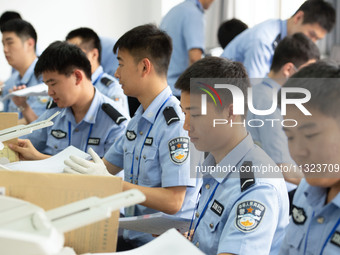 Staff members are performing an orderly scan at a scanning point for the Jiangsu Provincial College Entrance Examination answer sheet in Nan...