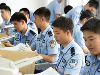 Staff members are performing an orderly scan at a scanning point for the Jiangsu Provincial College Entrance Examination answer sheet in Nan...