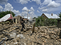 A police officer is recording damage next to a house that is partially destroyed by a Russian drone attack in Orikhiv, Zaporizhzhia region,...