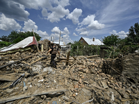 A police officer is recording damage next to a house that is partially destroyed by a Russian drone attack in Orikhiv, Zaporizhzhia region,...