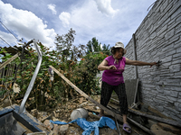 An elderly woman is walking through the rubble at a house that is partially destroyed by a Russian drone attack in Orikhiv, Zaporizhzhia reg...