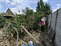 An elderly woman is walking through the rubble at a house that is partially destroyed by a Russian drone attack in Orikhiv, Zaporizhzhia reg...