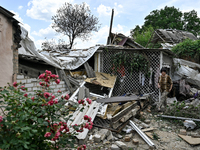 An elderly woman is walking through the premises of a house that was partially destroyed by a Russian drone attack in Orikhiv, Zaporizhzhia...