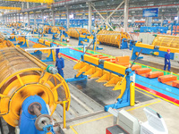 A worker is producing special cable products in Huzhou, China, on June 12, 2024. (