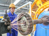 A worker is producing special cable products in Huzhou, China, on June 12, 2024. (