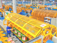 A worker is producing special cable products in Huzhou, China, on June 12, 2024. (